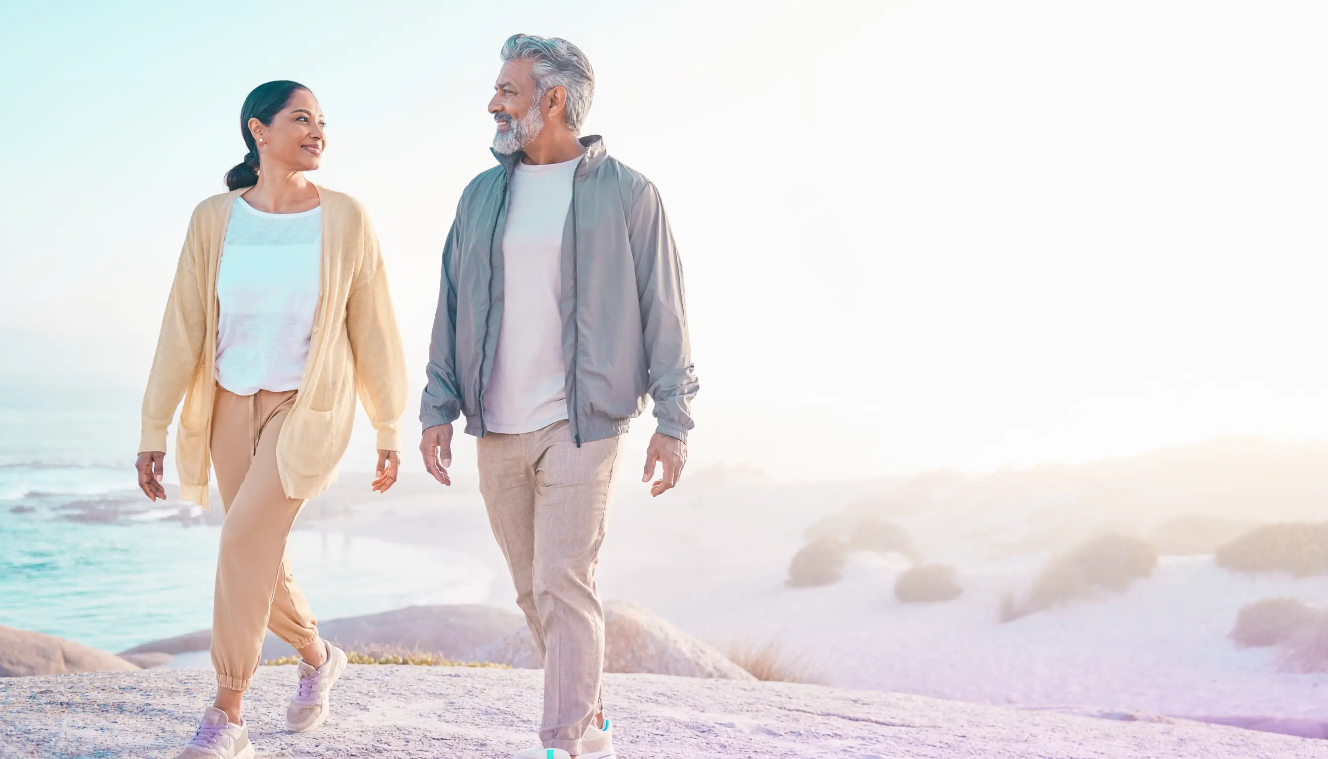 Active midlife couple enjoying a relaxed coastal walk